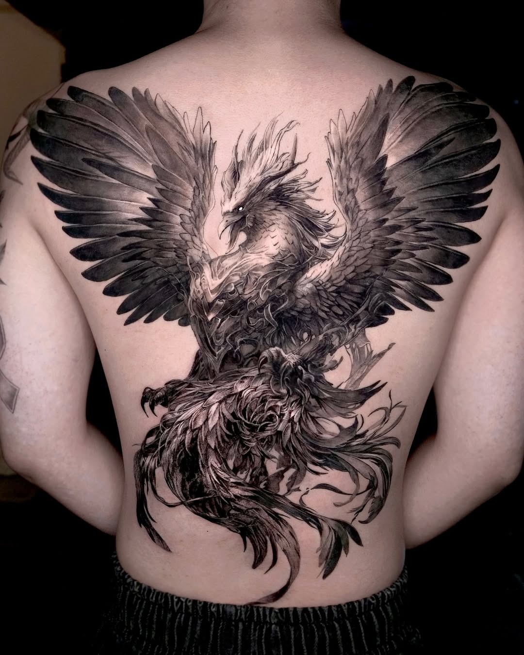 Majestic phoenix tattoo soaring across the back Tattoo Design