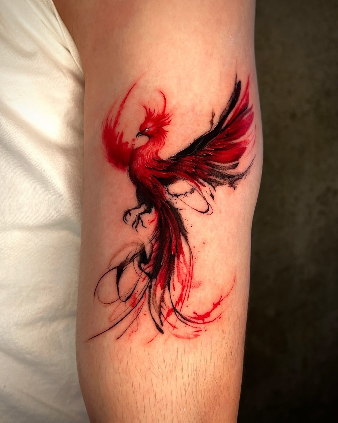 Striking phoenix tattoo in fiery hues Tattoo Design