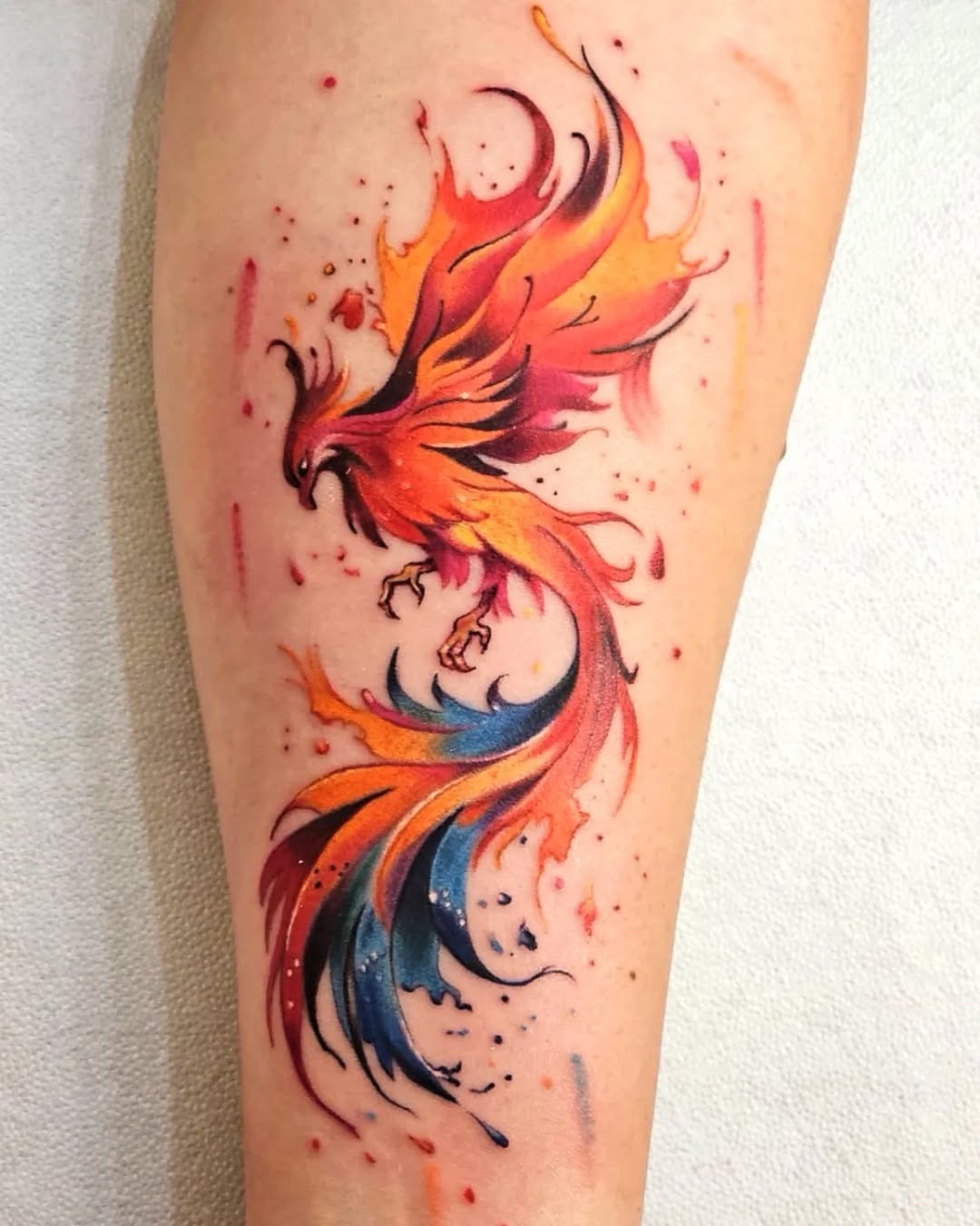 Stunning vibrant phoenix tattoo in motion. Tattoo Design