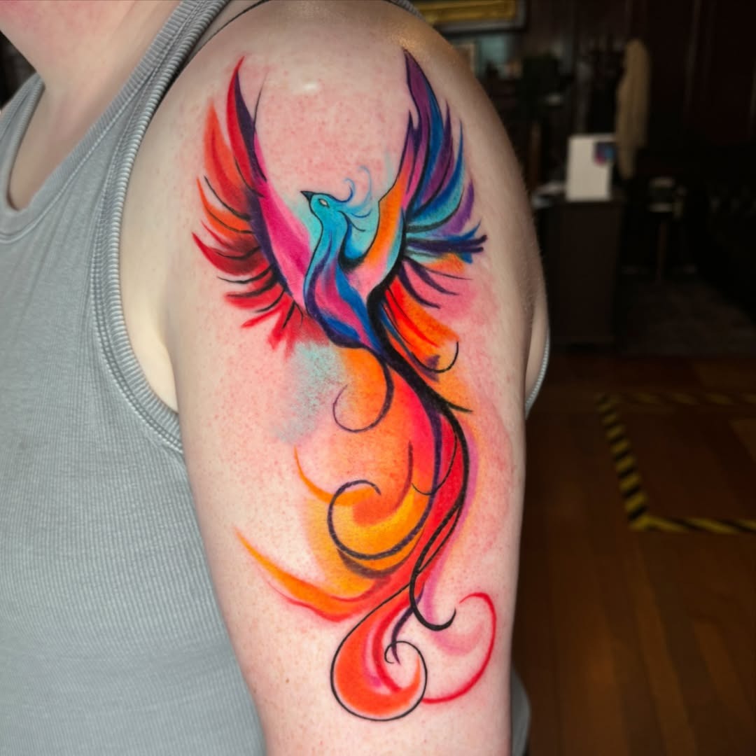 Vibrant Phoenix Tattoo with Colorful Flames Tattoo Design