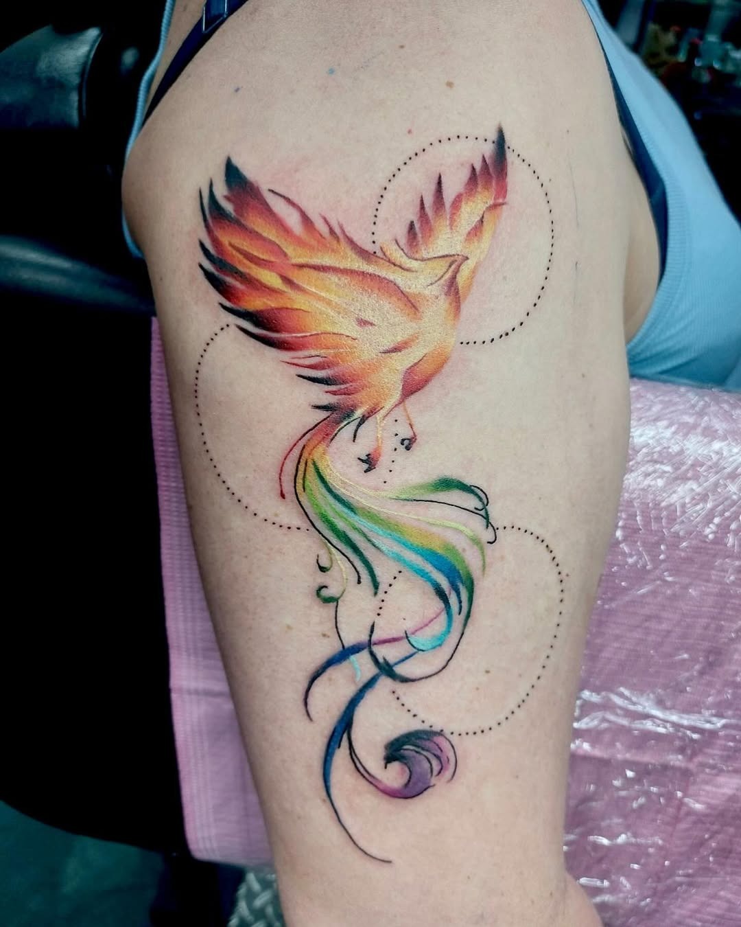 Vivid phoenix tattoo showcasing rainbow hues Tattoo Design