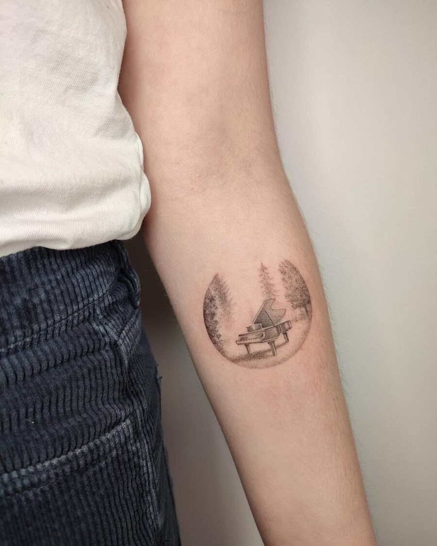 Beautiful piano tattoo within a forest circle Tattoo Design
