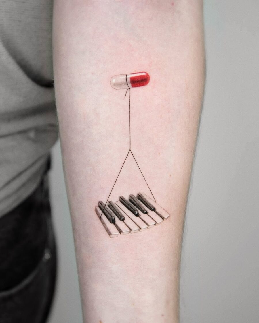 Creative piano and pill tattoo design Tattoo Design