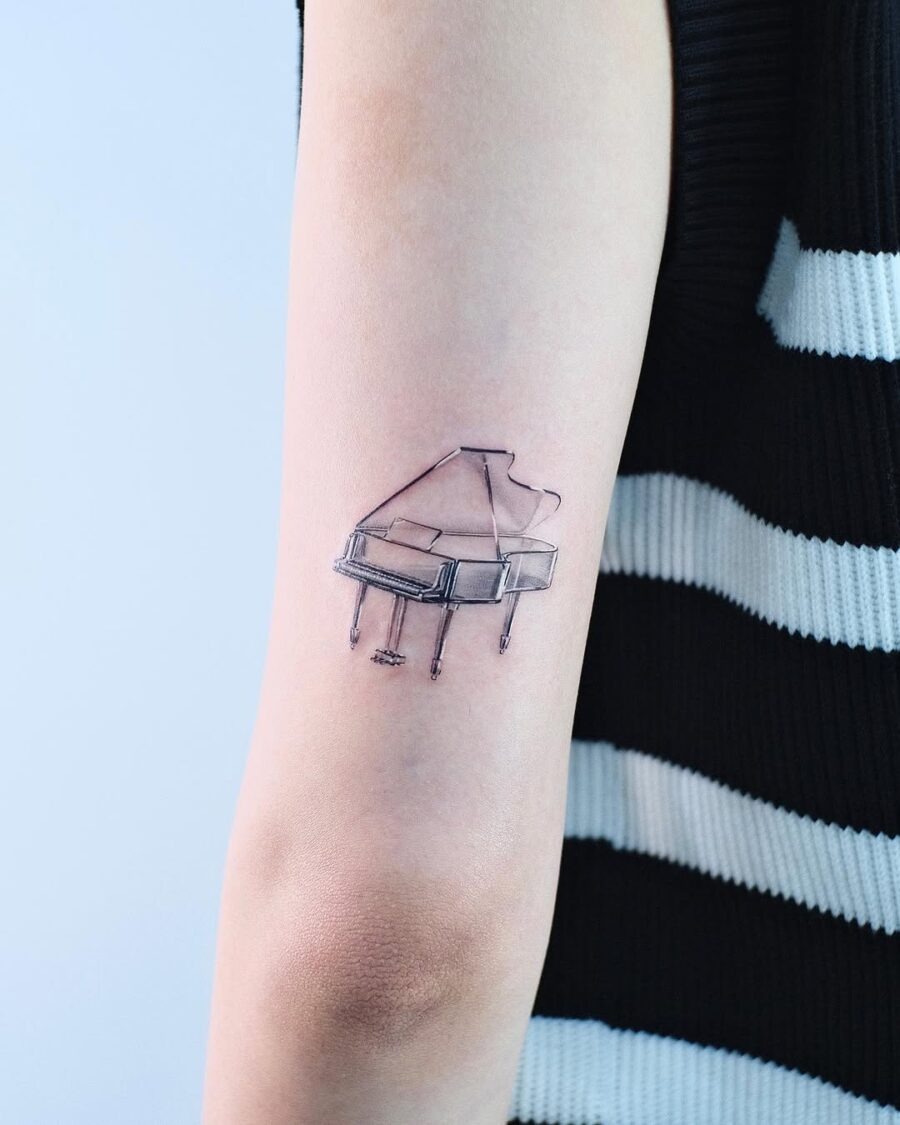 Elegant minimalist piano tattoo on forearm Tattoo Design