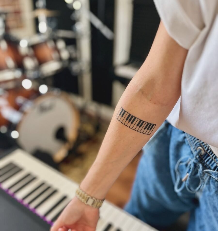 Elegant piano keys tattoo on forearm Tattoo Design