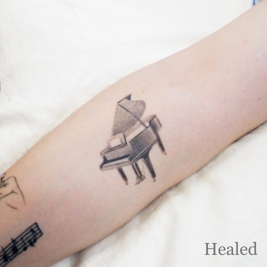 Elegant piano tattoo for music lovers Tattoo Design