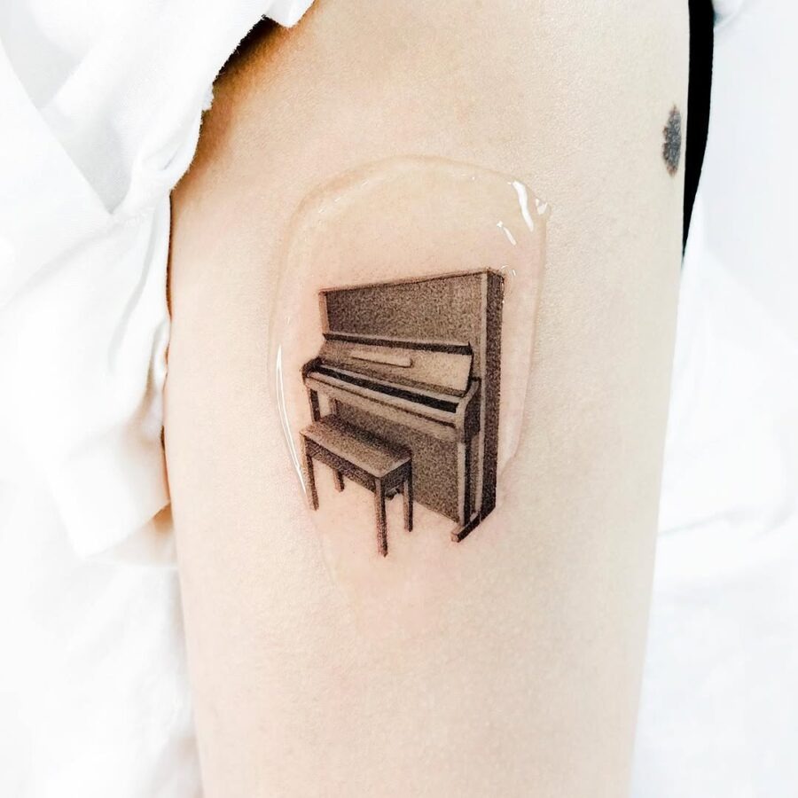 Elegant piano tattoo in realistic style Tattoo Design