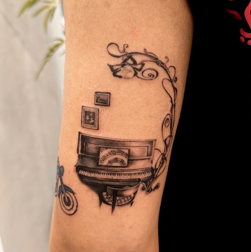 Elegant piano tattoo with artistic flourishes Tattoo Design