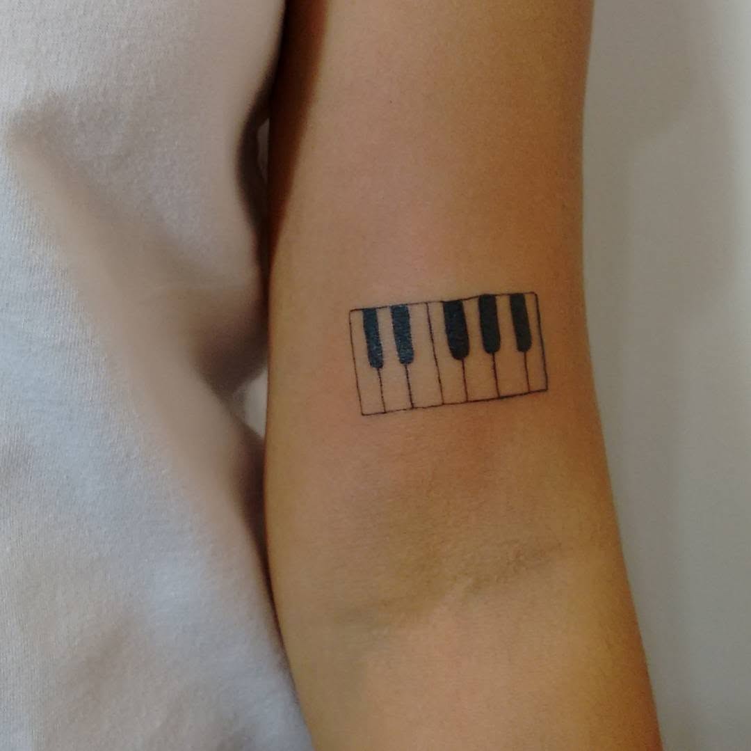 Minimalist piano tattoo on forearm Tattoo Design