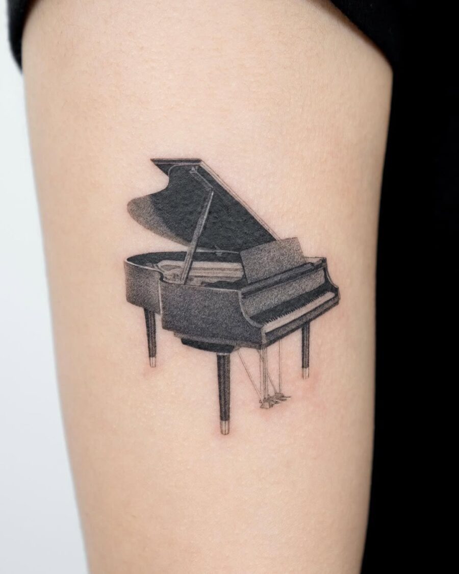 Sleek Grand Piano Tattoo on Upper Arm Tattoo Design