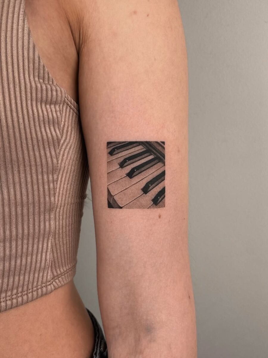 Stylish piano keys tattoo on the arm Tattoo Design