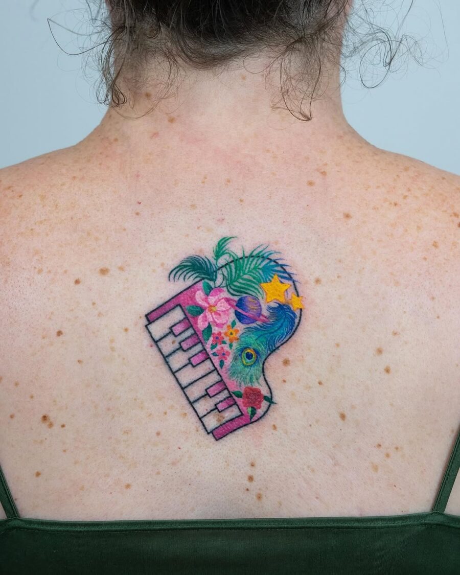Vibrant floral piano tattoo on the back Tattoo Design