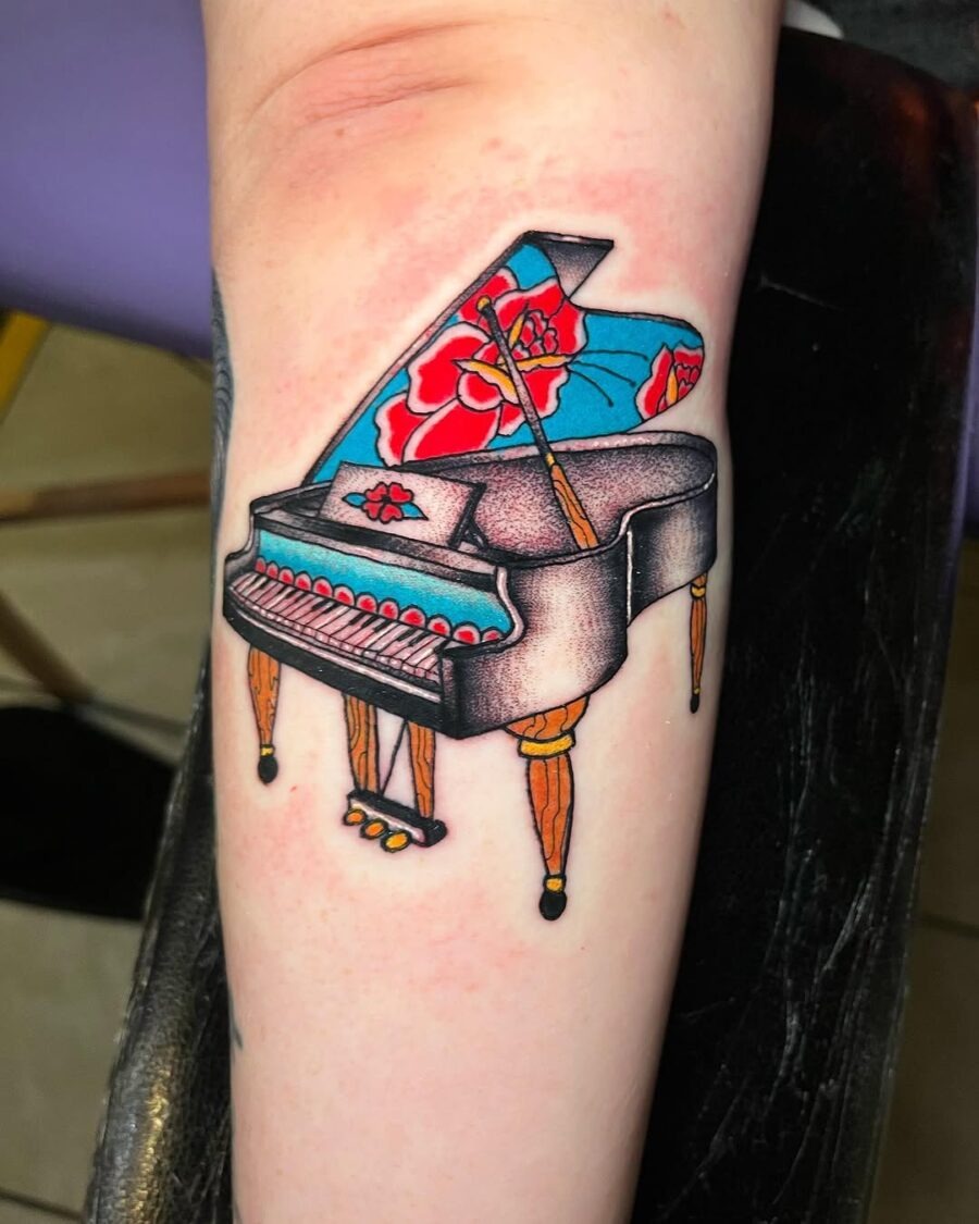Vibrant grand piano tattoo with floral elements Tattoo Design