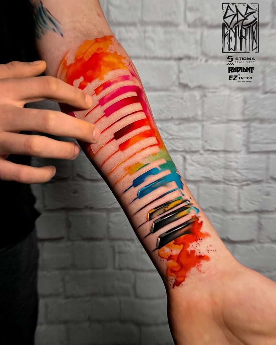 Vibrant Watercolor Piano Tattoo on Forearm Tattoo Design