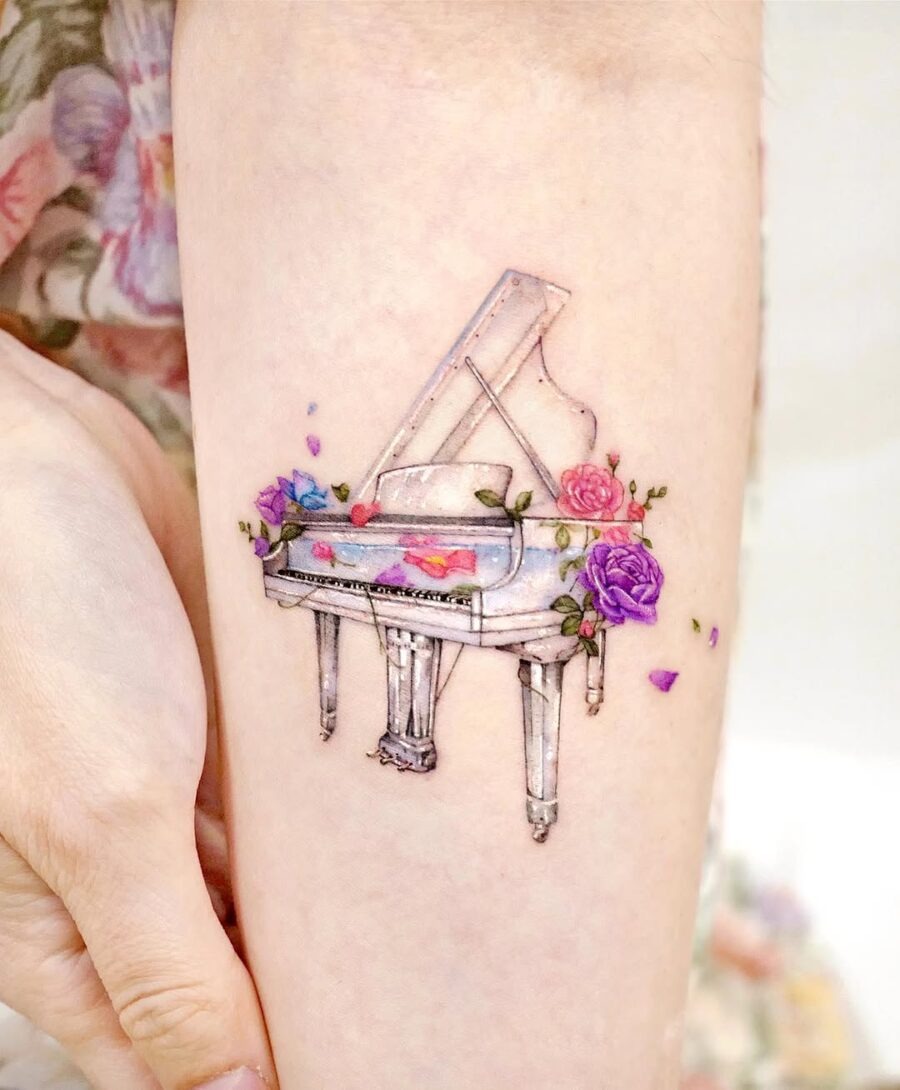 Whimsical piano tattoo adorned with flowers Tattoo Design