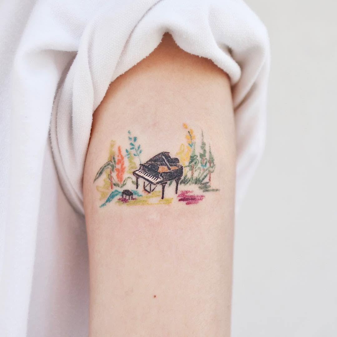 Whimsical piano tattoo with vibrant floral elements Tattoo Design