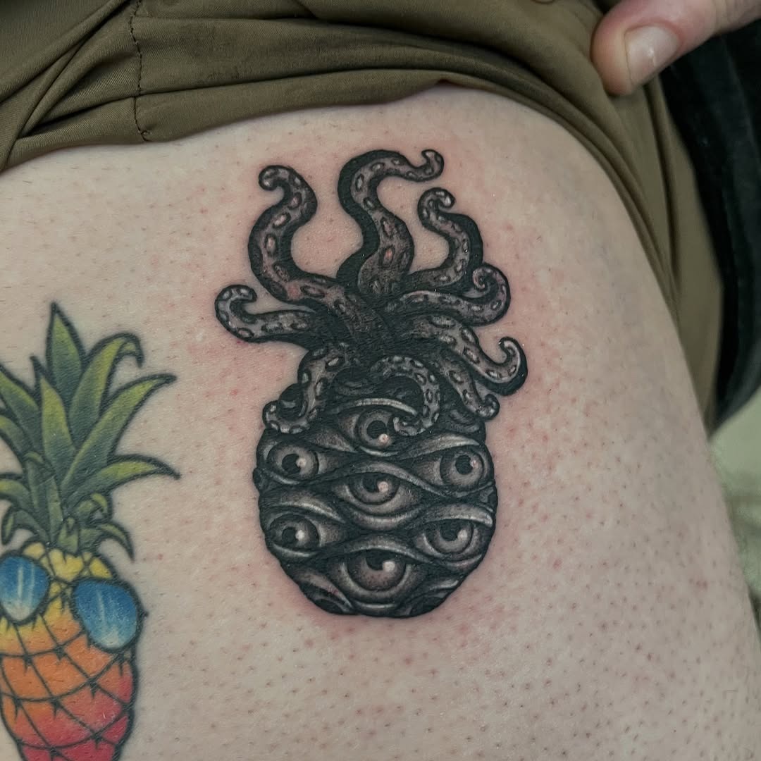 Adorable pineapple tattoo on the ear Tattoo Design
