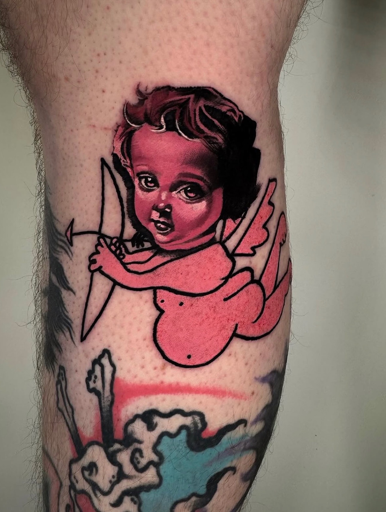 Charming cherub tattoo in soft pink hues Tattoo Design