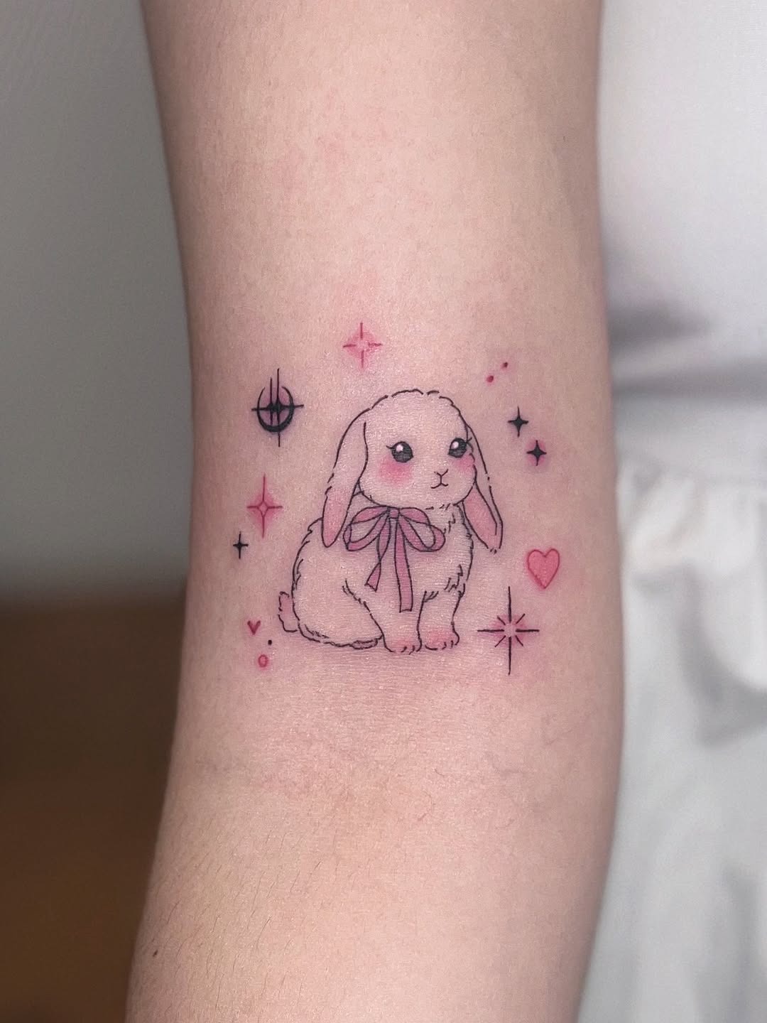 Charming pink bunny tattoo with whimsical stars Tattoo Design