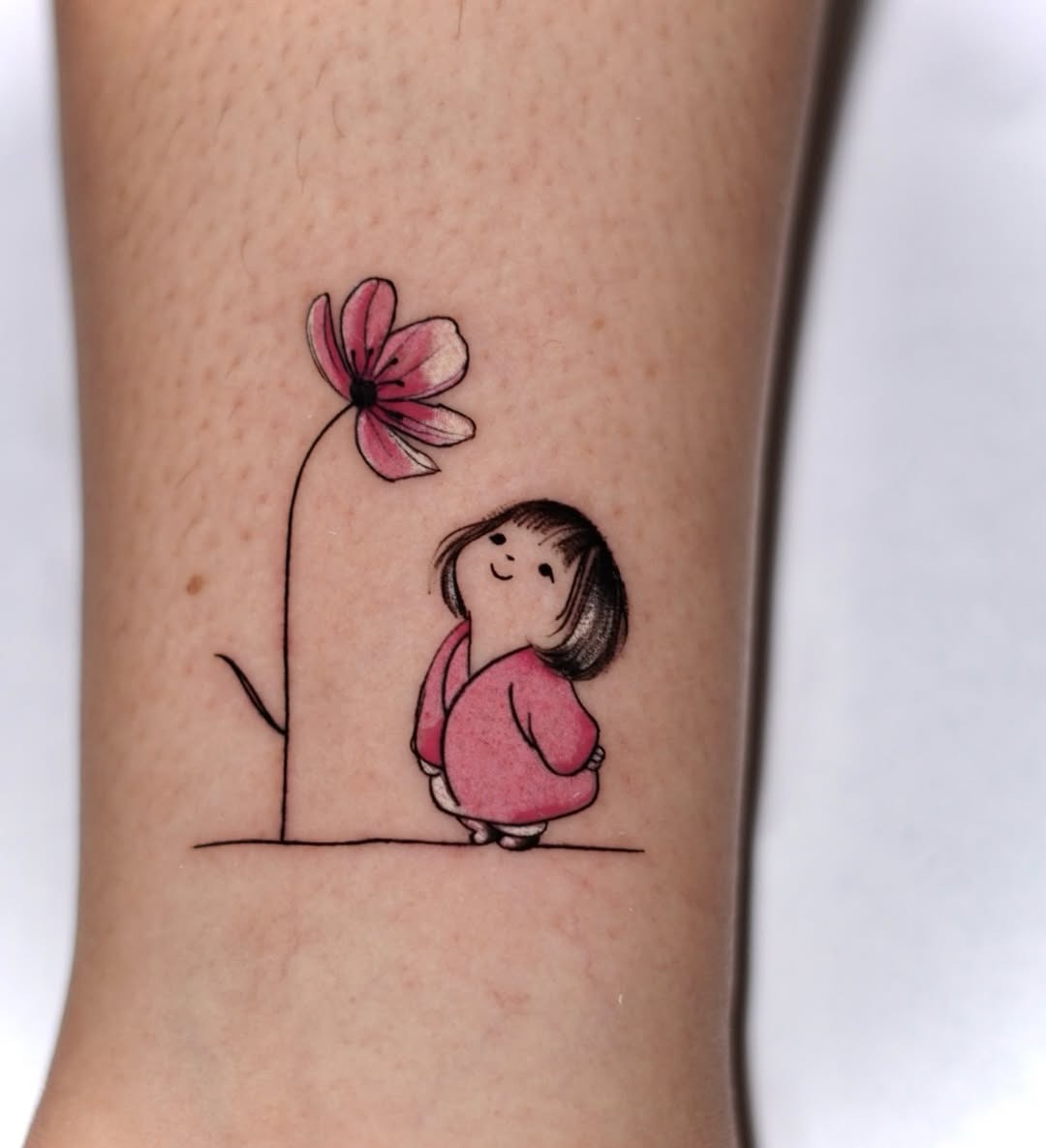 Charming pink flower with playful girl tattoo Tattoo Design