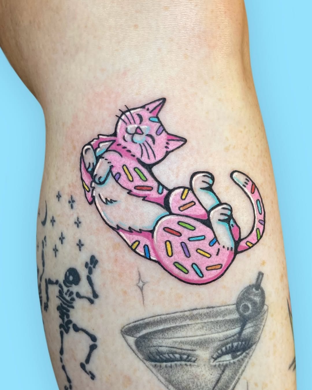Cute cat tattoo with playful sprinkles design Tattoo Design