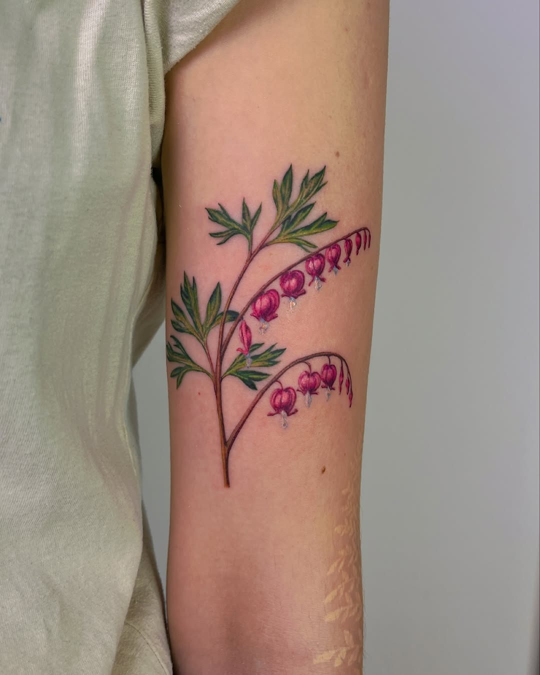 Delicate pink floral tattoo on the arm Tattoo Design