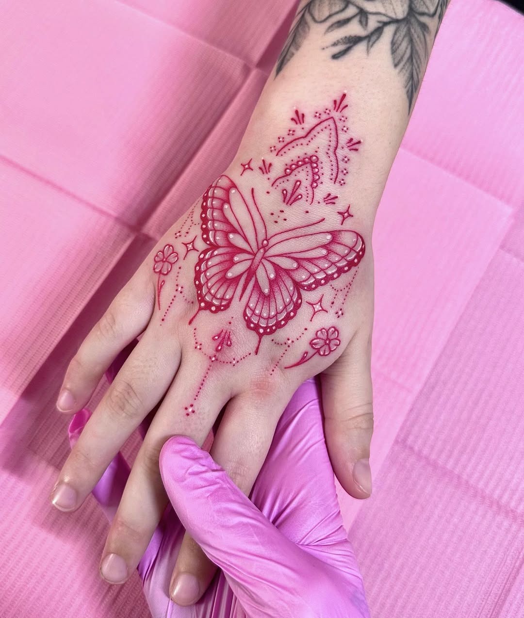 Vibrant pink butterfly hand tattoo design Tattoo Design