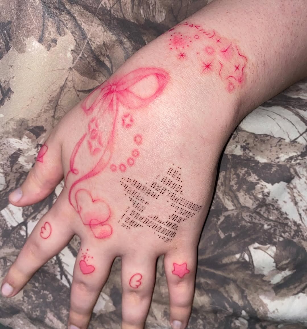 Whimsical pink tattoo designs on hand Tattoo Design