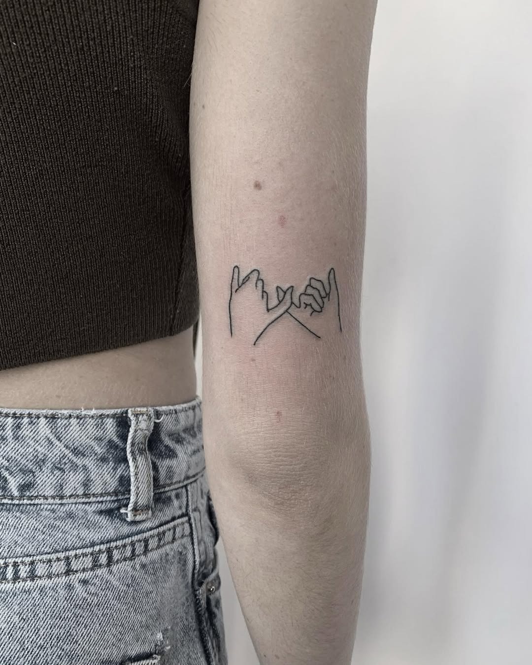 Artistic pinky promise tattoo with floral accents Tattoo Design