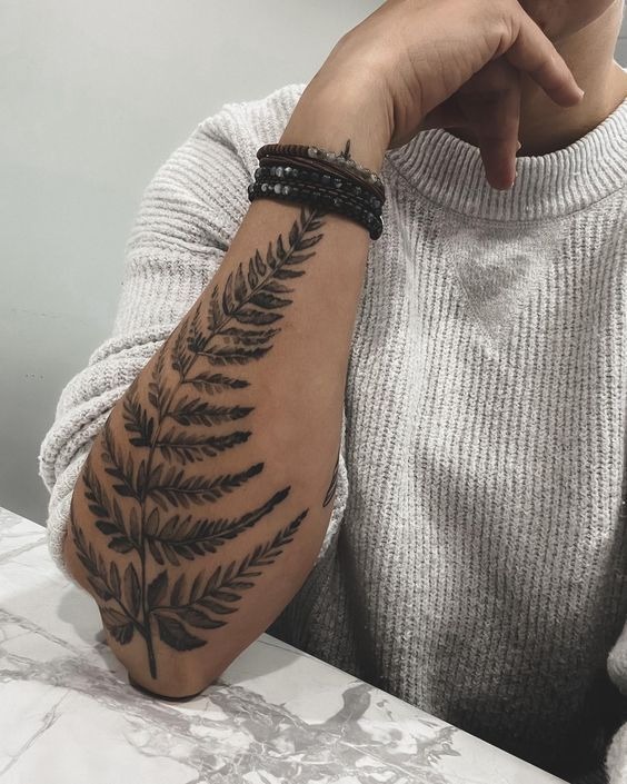Minimalist Fern Sweep on the Arm Tattoo Design