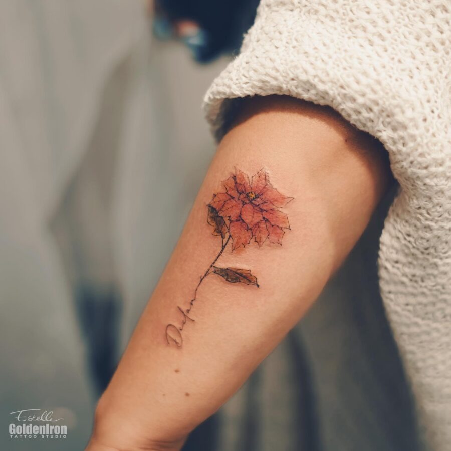 Delicate poinsettia tattoo on an elegant arm Tattoo Design