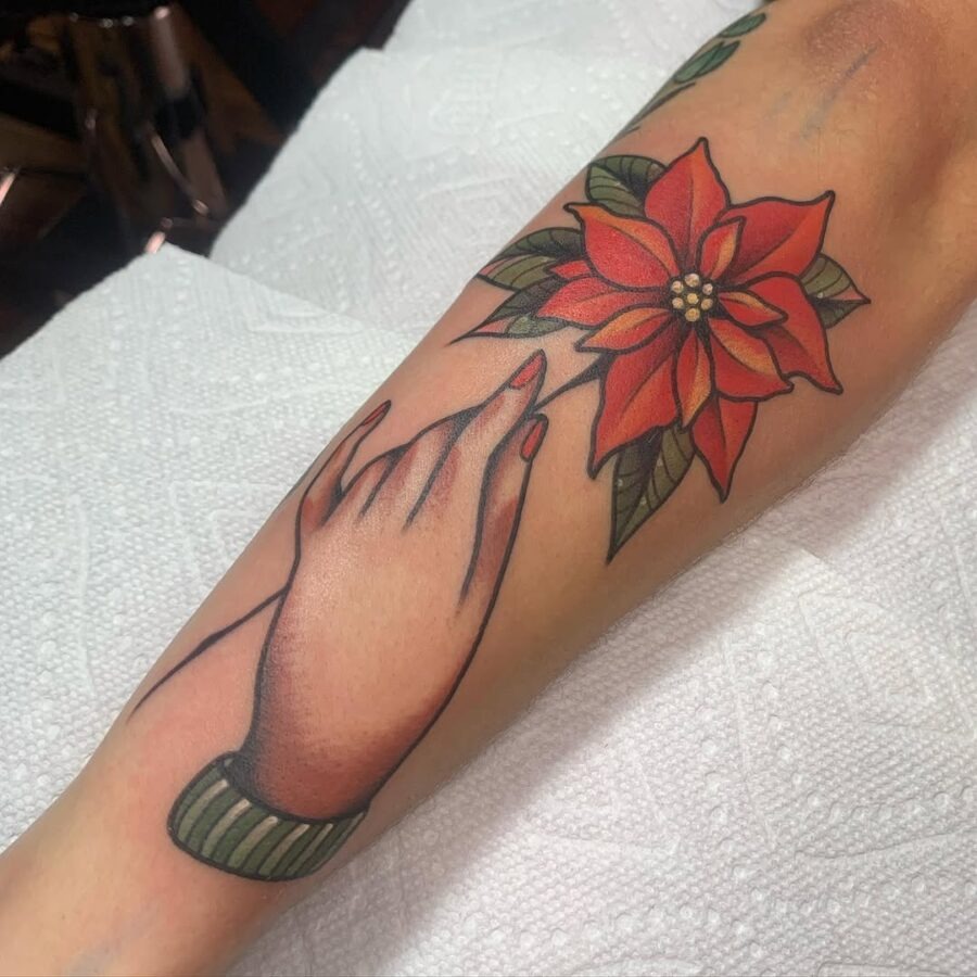 Elegant poinsettia tattoo with hand gesture Tattoo Design