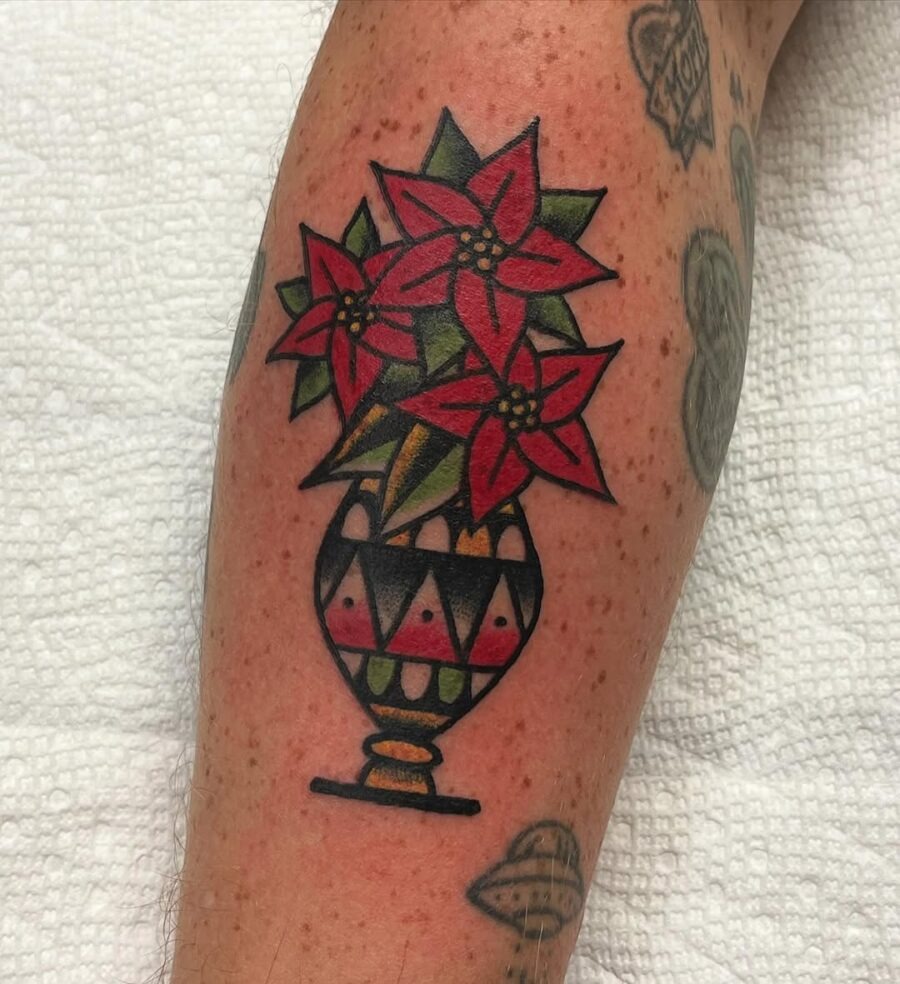 Vibrant poinsettia tattoo in a decorative vase Tattoo Design