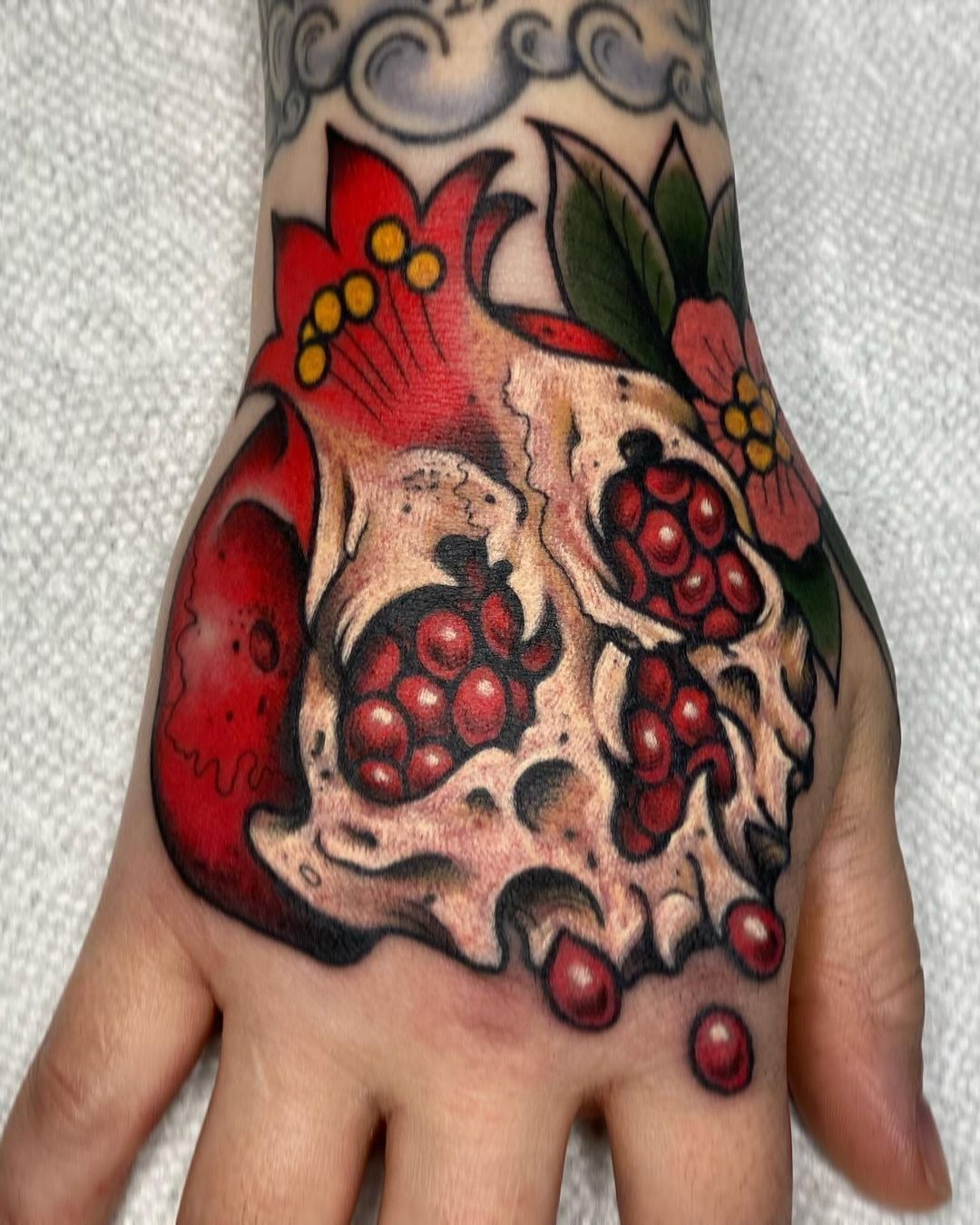 Floral Pomegranate with Soft Botanical Accents Tattoo Design