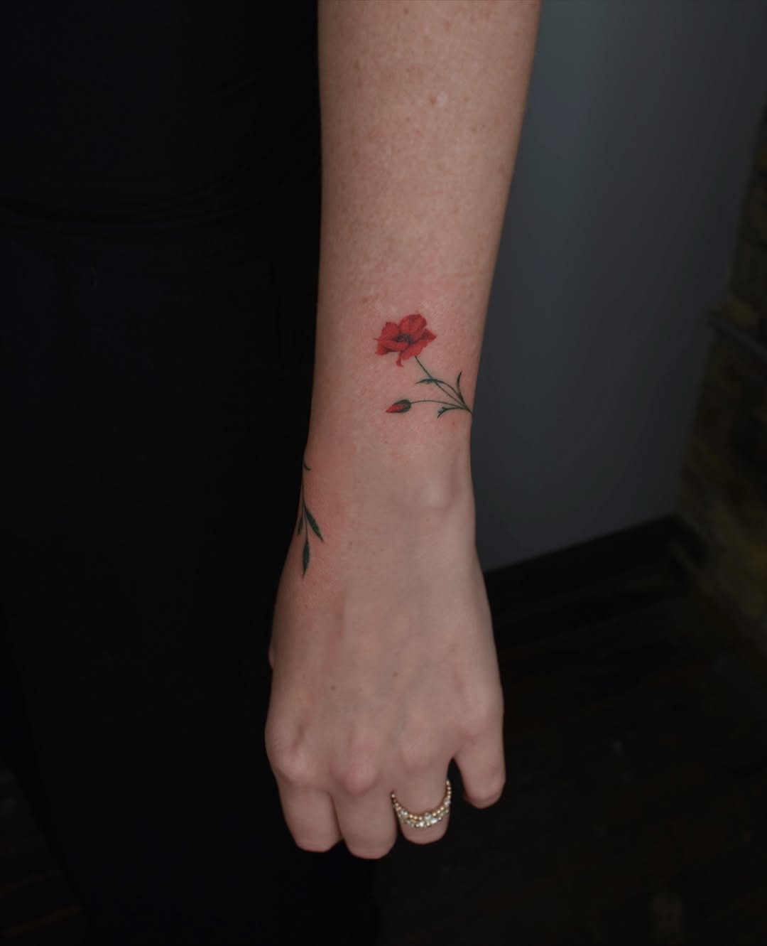 Elegant poppy tattoo on delicate wrist. Tattoo Design