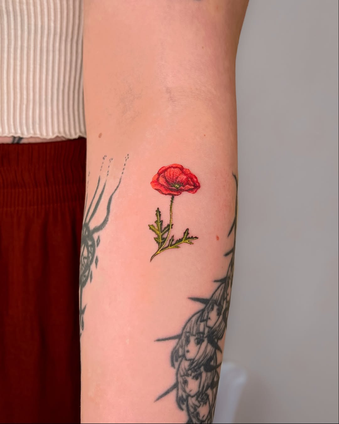 Elegant poppy tattoo on forearm Tattoo Design