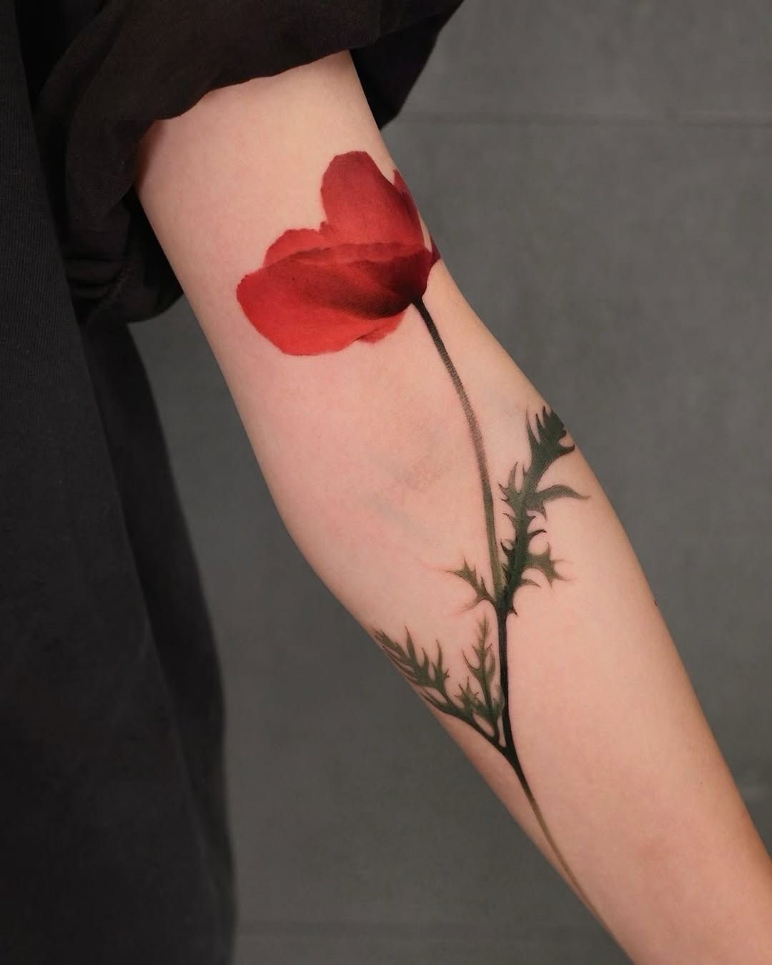 Elegant red poppy tattoo on the arm Tattoo Design