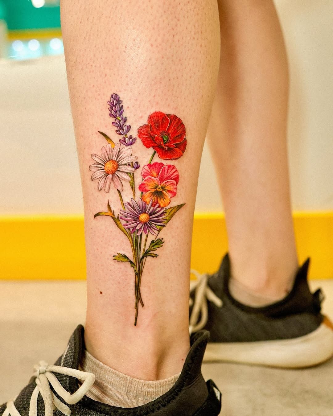 Vibrant floral poppy tattoo on the leg Tattoo Design