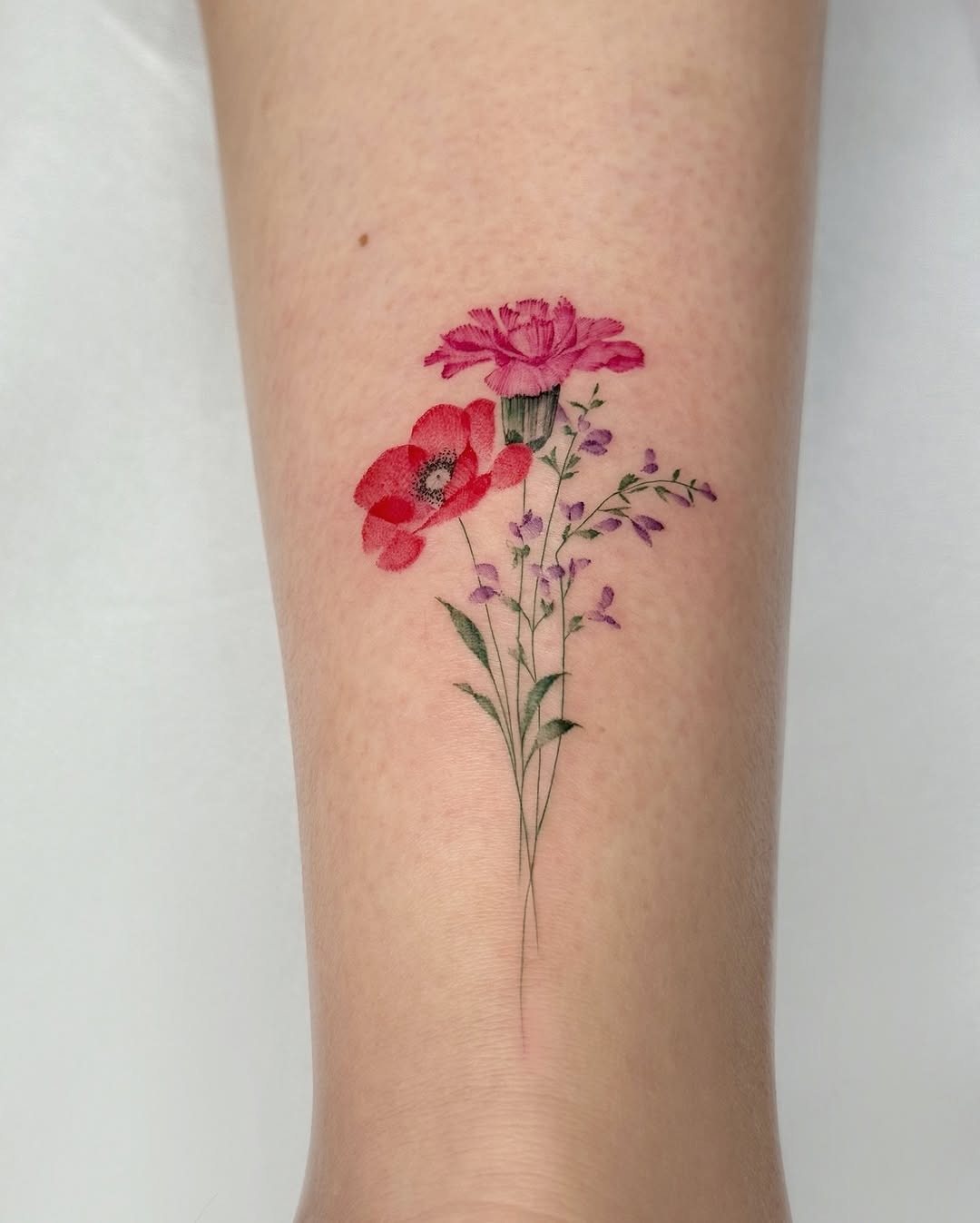 Vibrant poppy tattoo with delicate floral details Tattoo Design