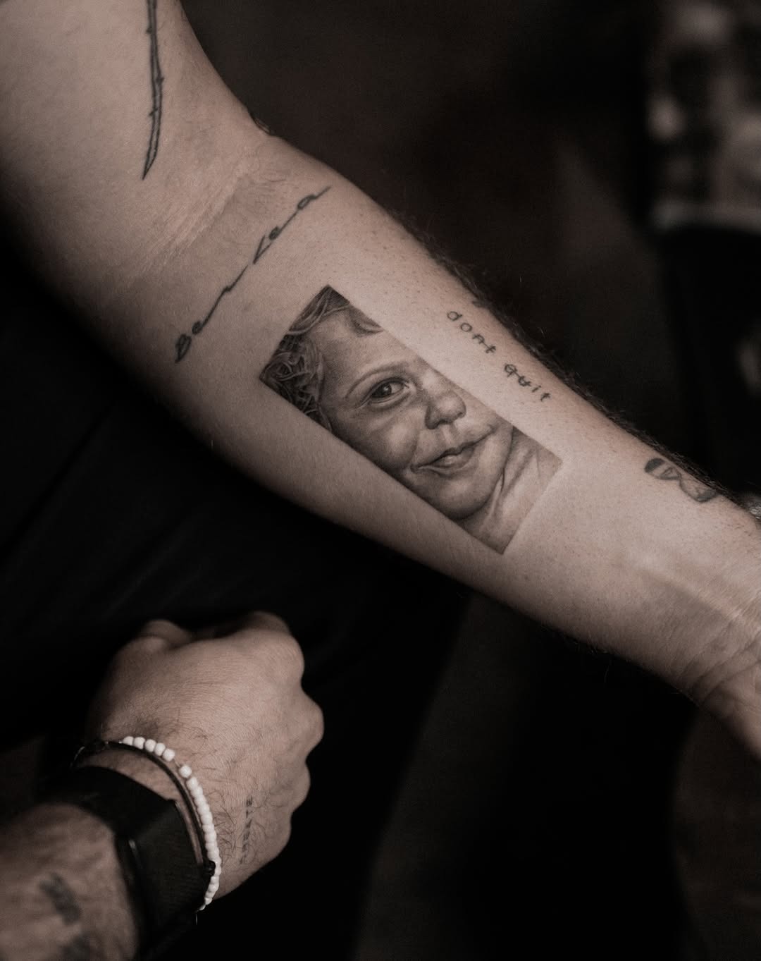 Unique portrait tattoo capturing a child’s smile Tattoo Design
