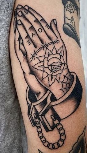 Bold Praying Hands Tattoo with Handcuffs and Rose Tattoo Design