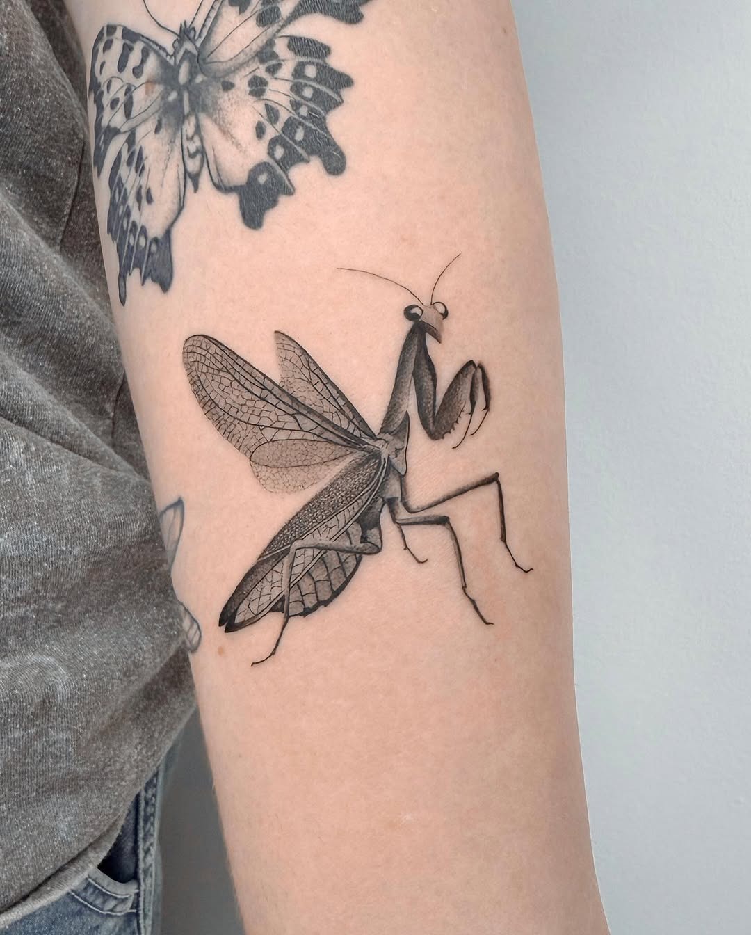 Intricate praying mantis tattoo design on arm Tattoo Design