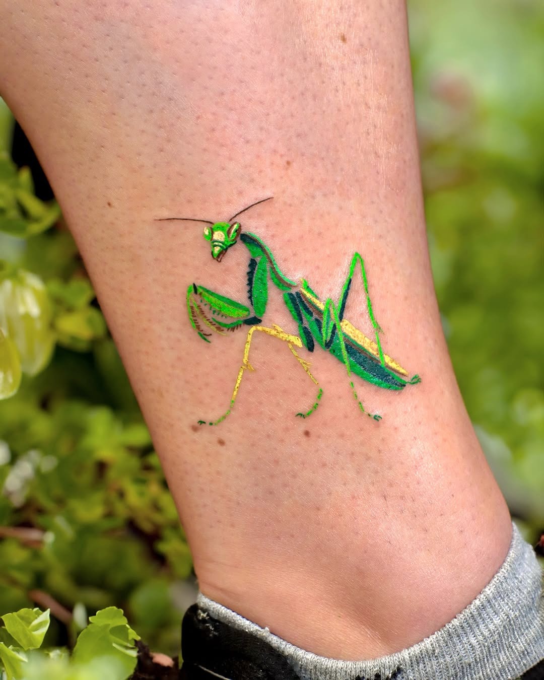 Stunning green praying mantis leg tattoo design Tattoo Design