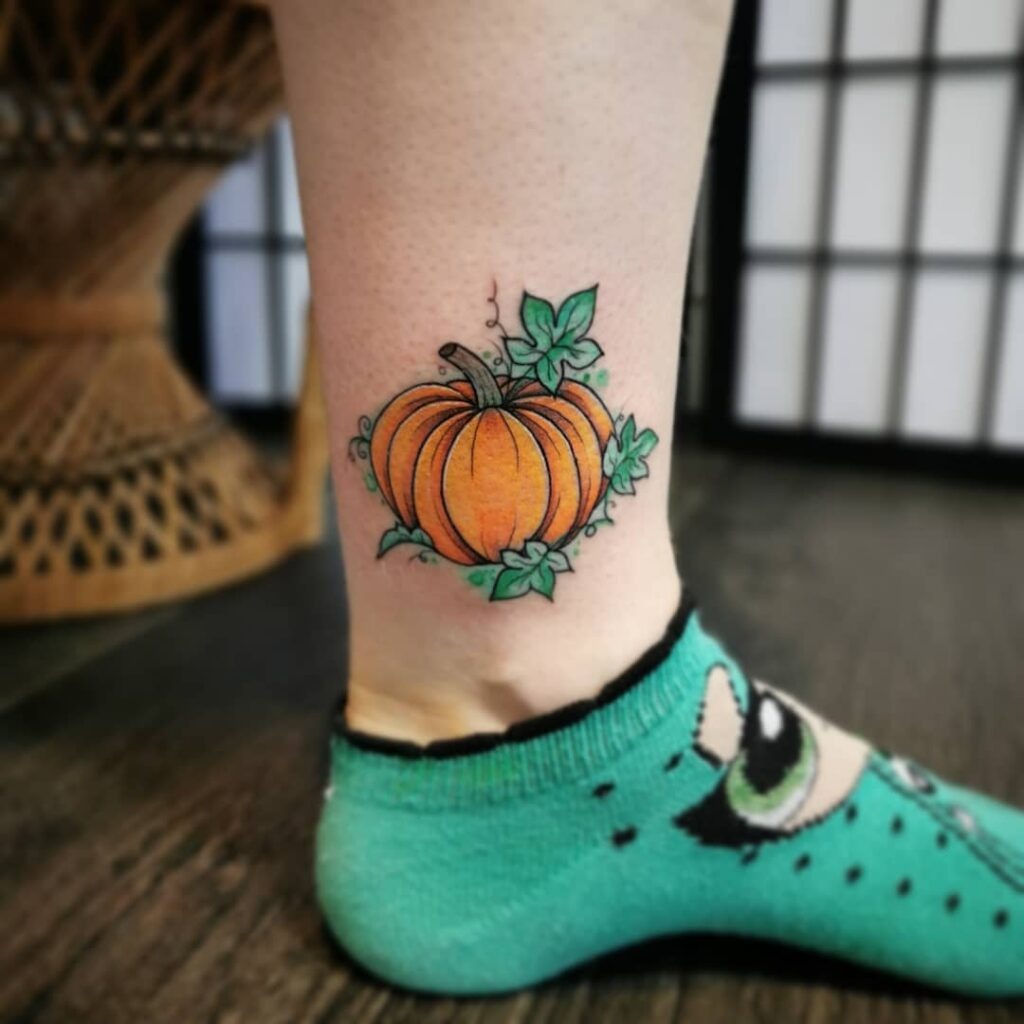 Bright Pumpkin with Lush Green Leaves Tattoo Design