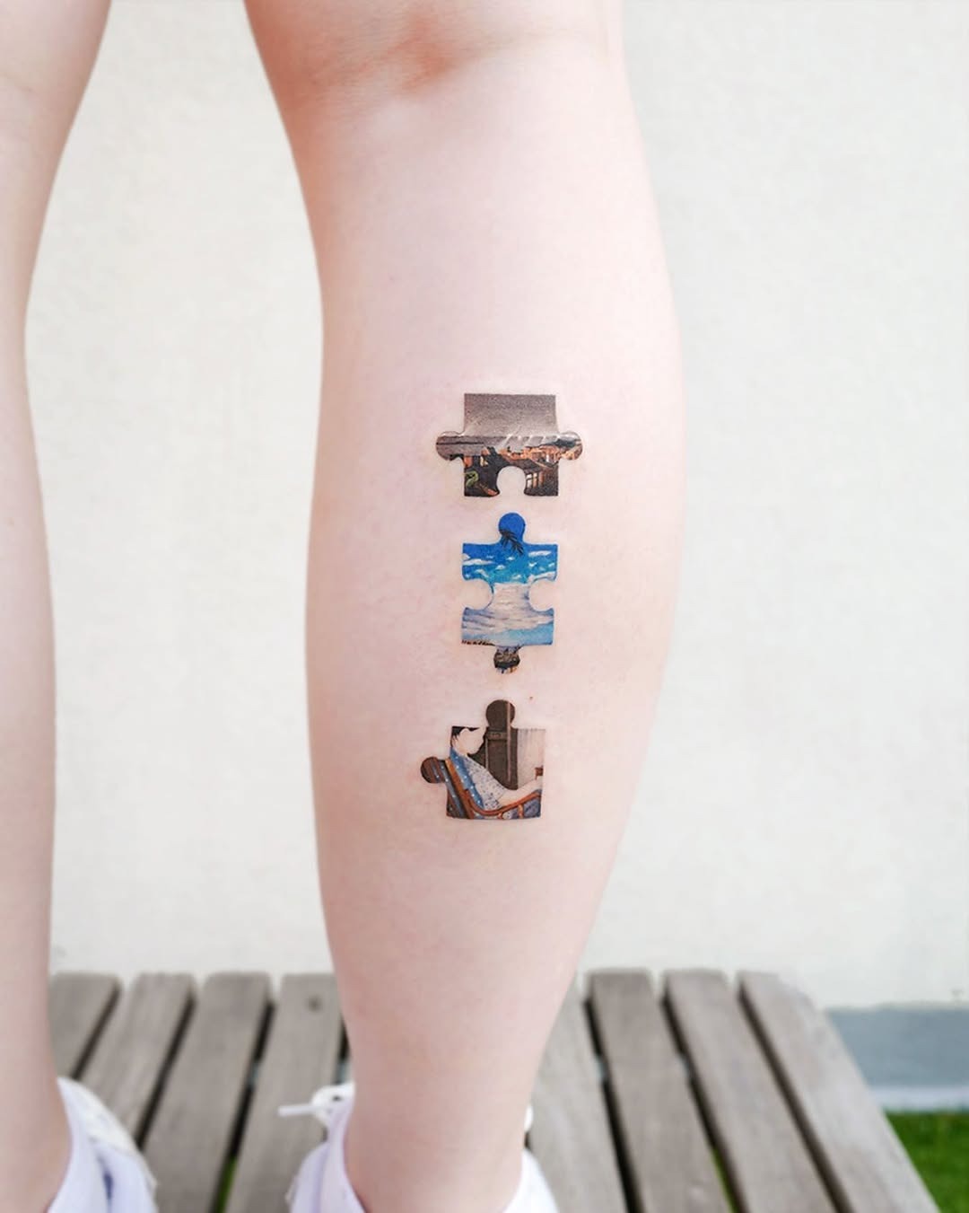 Artistic puzzle tattoo with vibrant imagery Tattoo Design