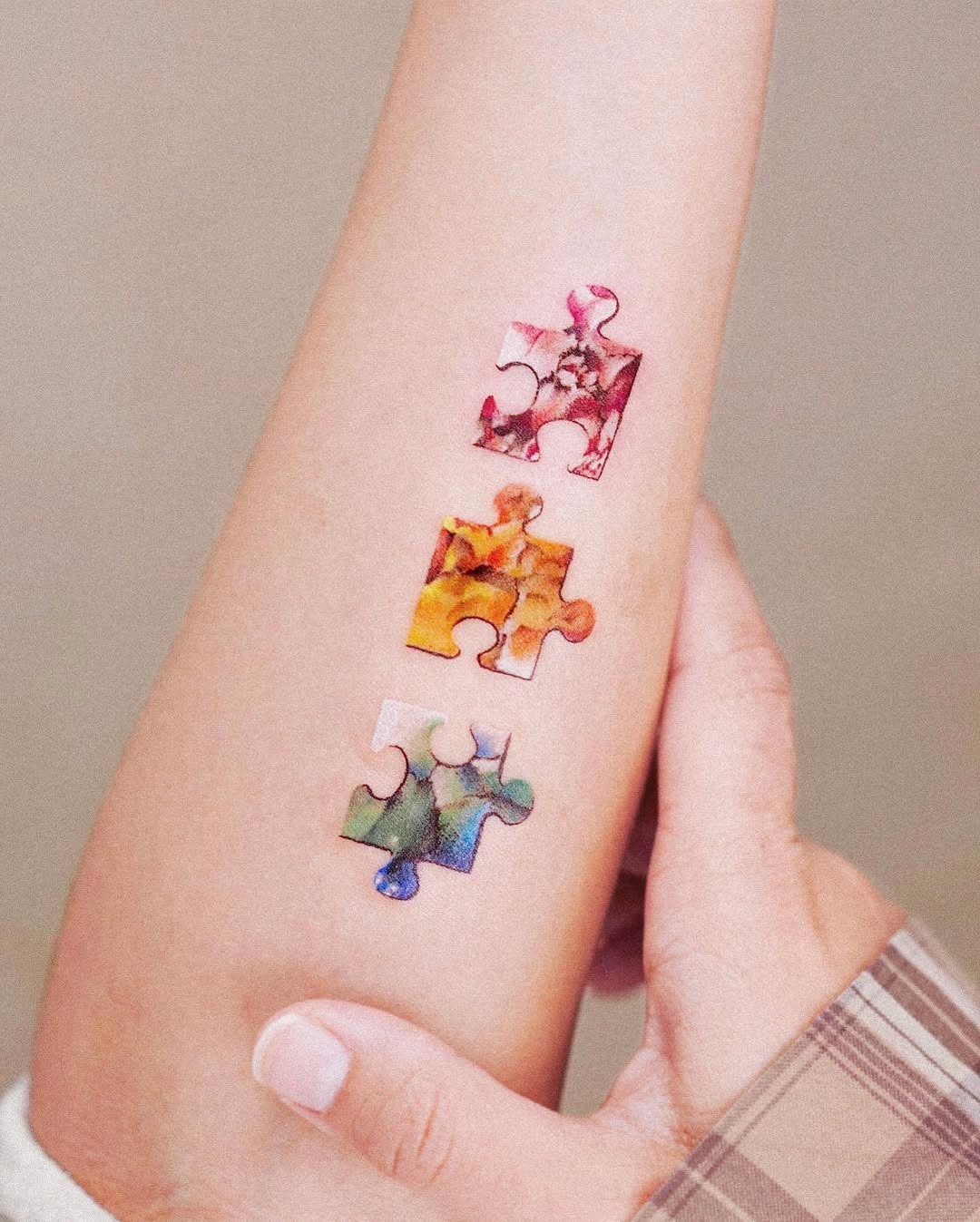 Colorful puzzle tattoos representing unique connections Tattoo Design