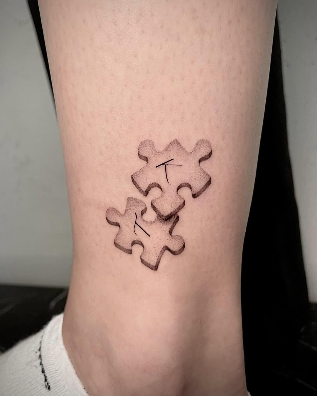 Intricate puzzle piece tattoo on the ankle Tattoo Design
