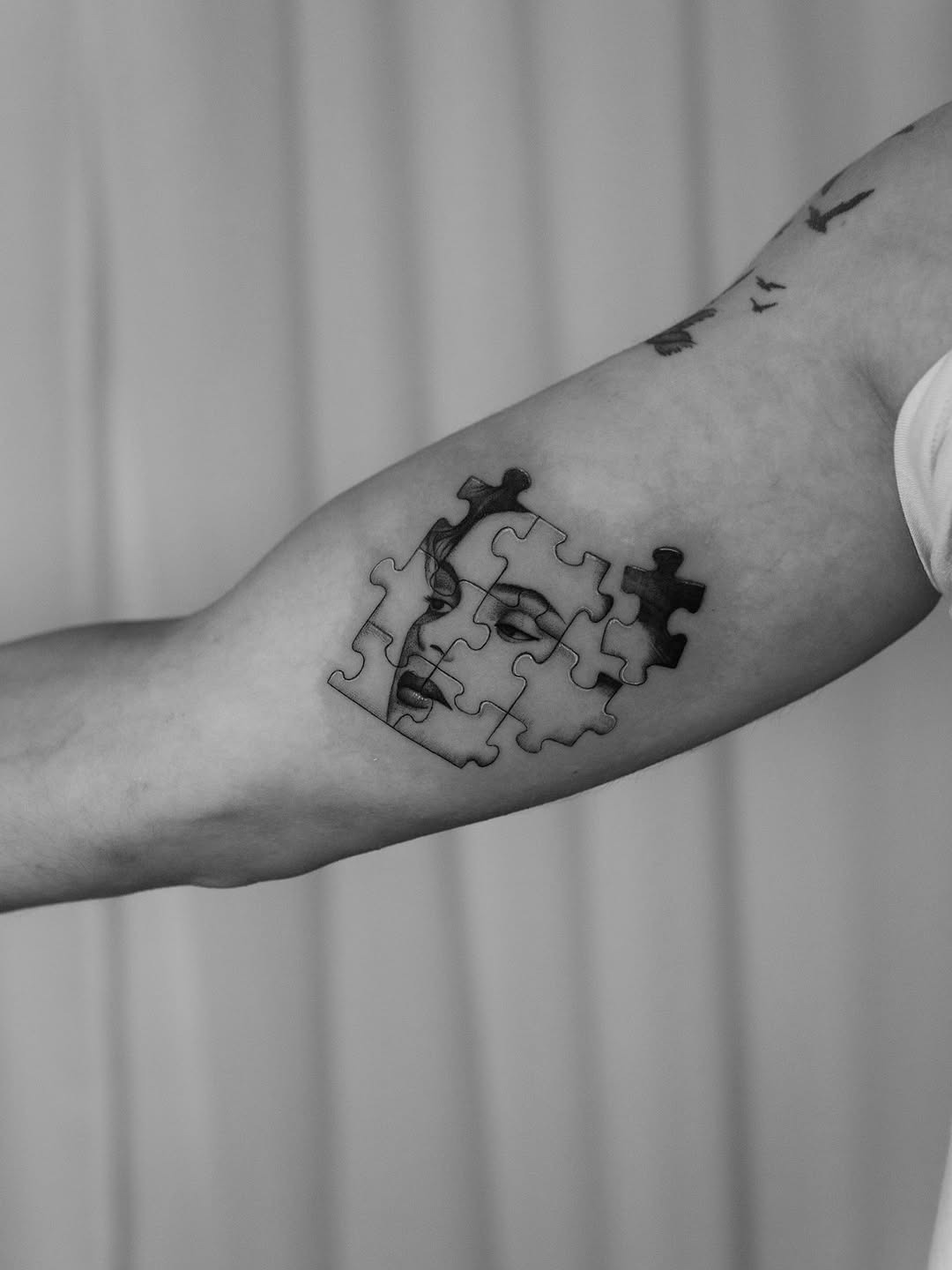 Intriguing puzzle tattoo blending faces and forms Tattoo Design