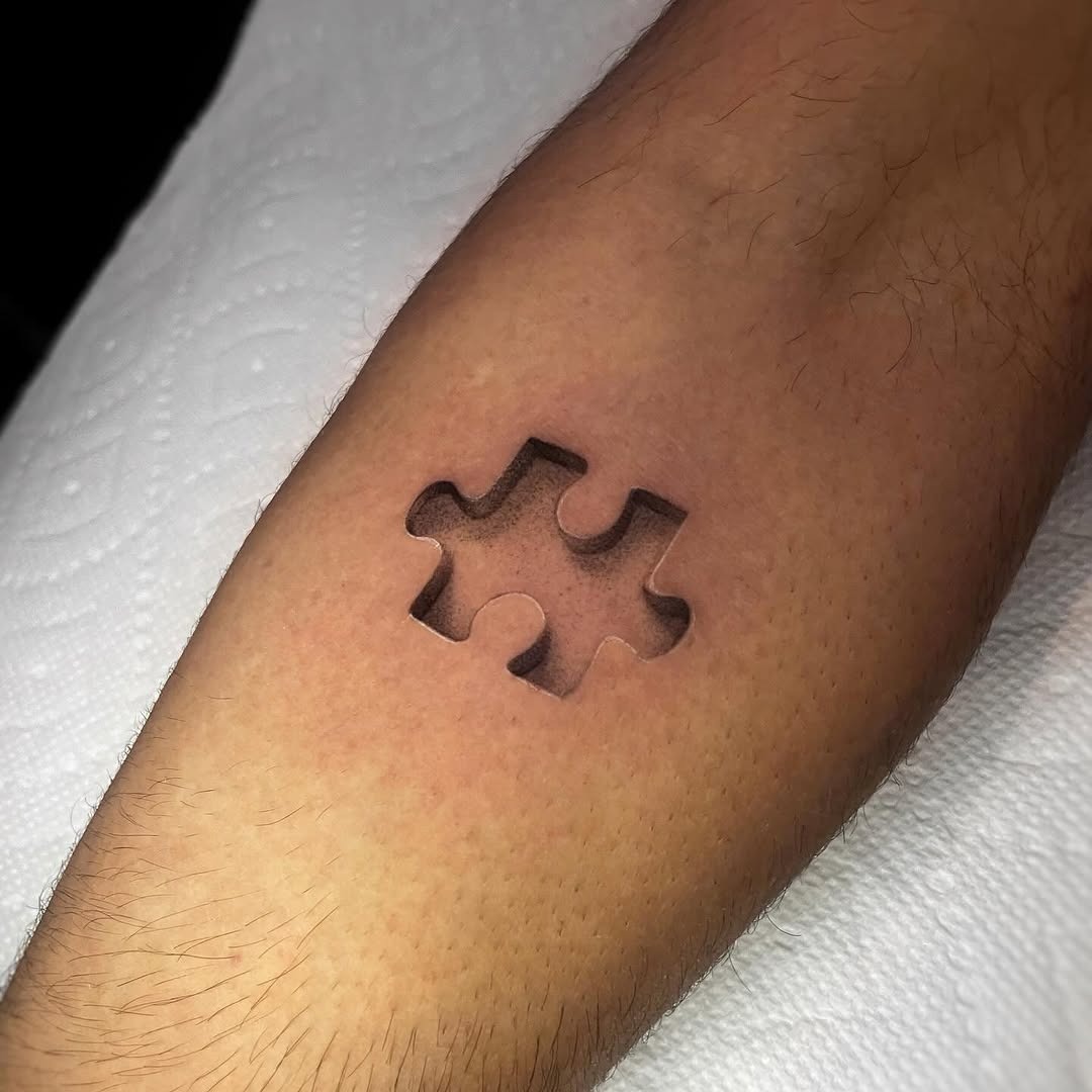 Minimalist puzzle piece tattoo on the arm Tattoo Design