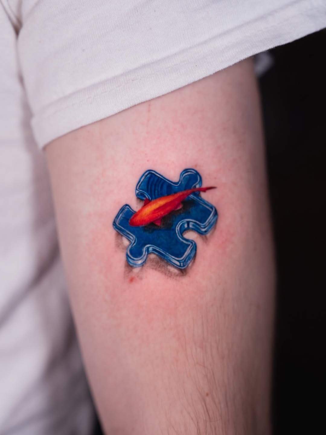 Vibrant goldfish within a puzzle piece tattoo Tattoo Design